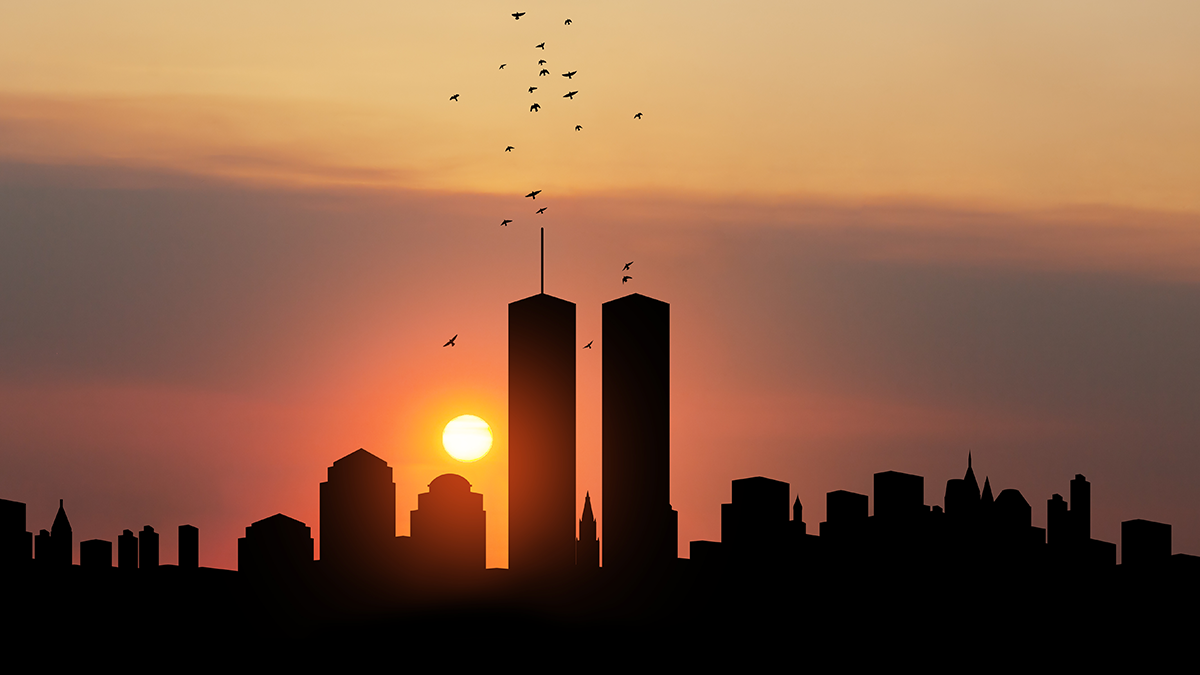 New York City skyline at sunset. Twin towers prominently featured with birds flying over them.