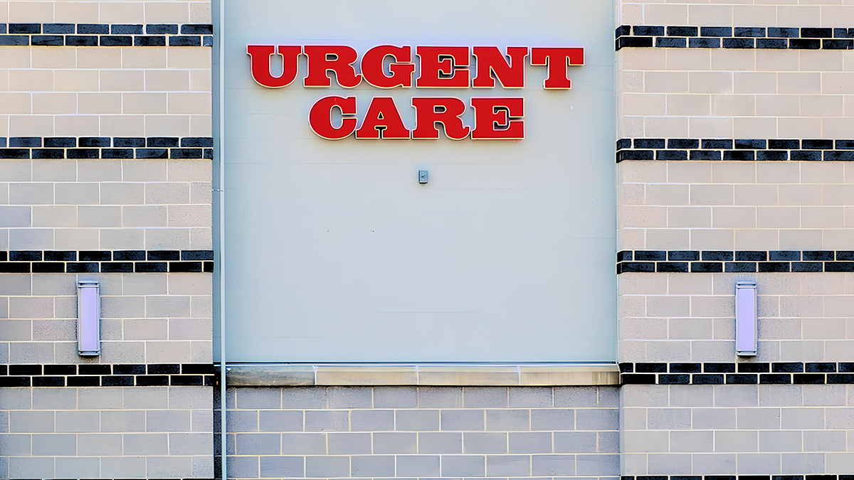 "Urgent Care" sign on a brick wall