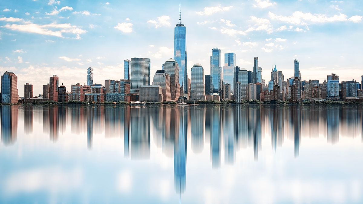 Daylight shines on water and NYC skyline