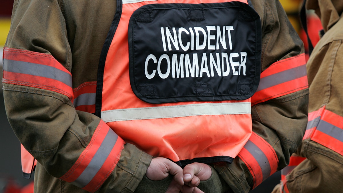 Shirt with black patch and white text saying Incident Commander