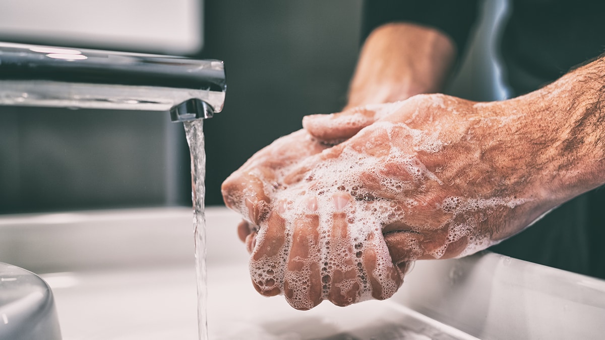 Close up of someone washing their hands.