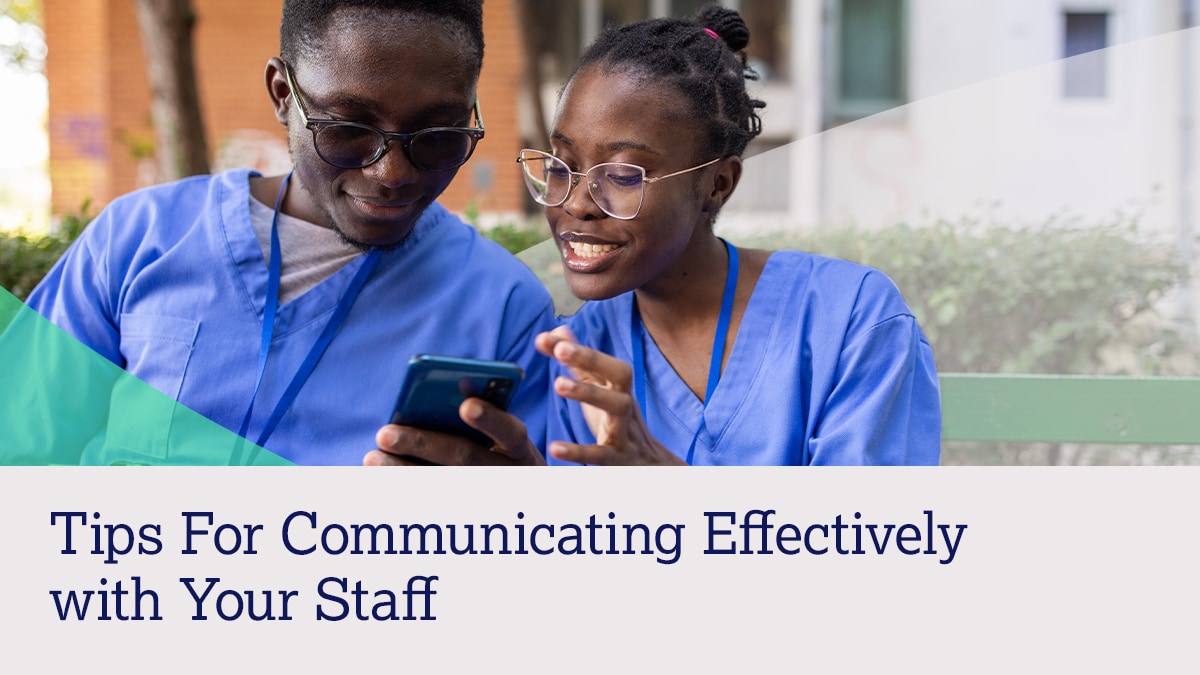 Two healthcare workers look at a phone together with text "Tips for Communicating Effectively with Your Staff."
