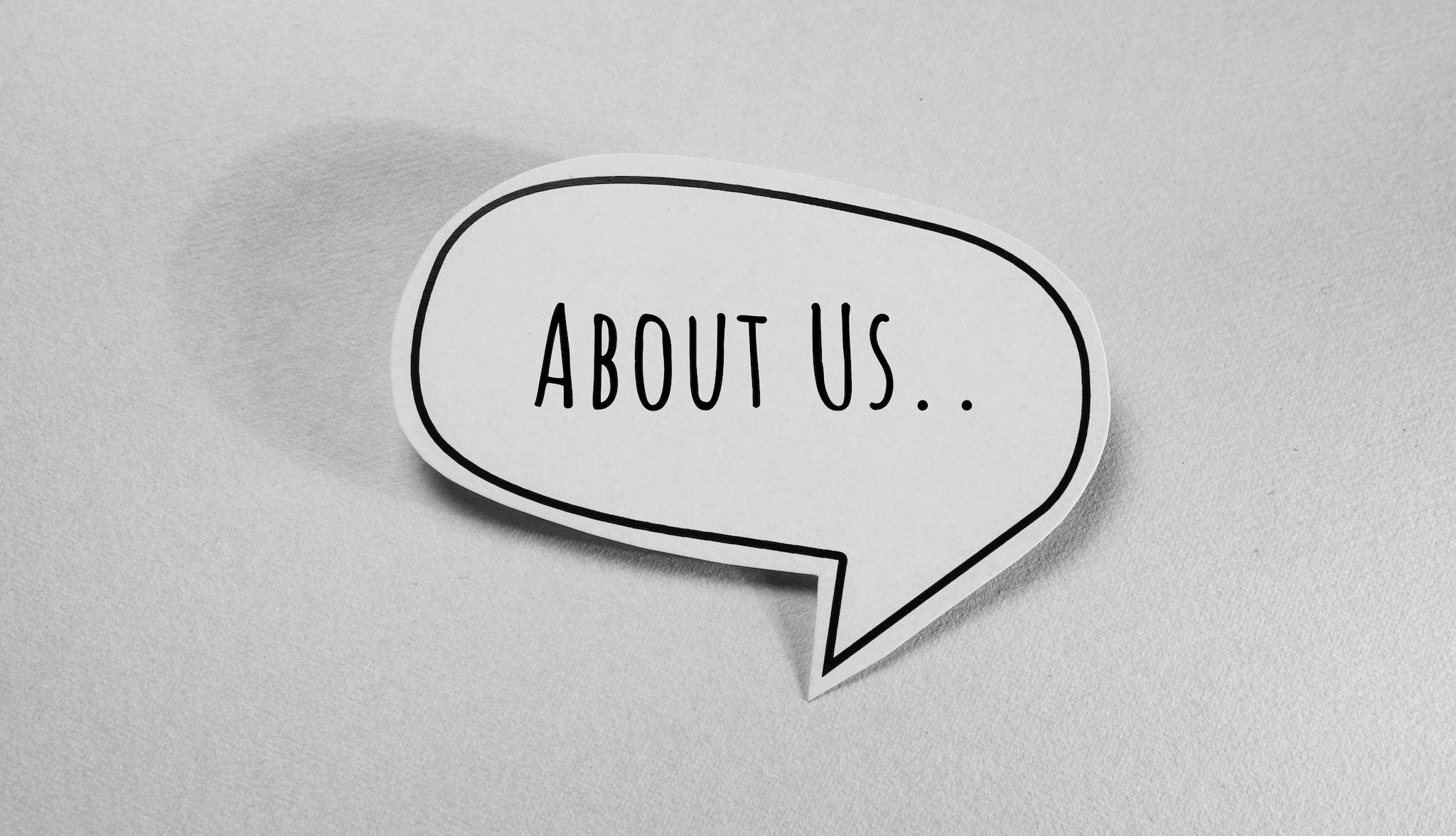 Speech bubble with "About Us" text