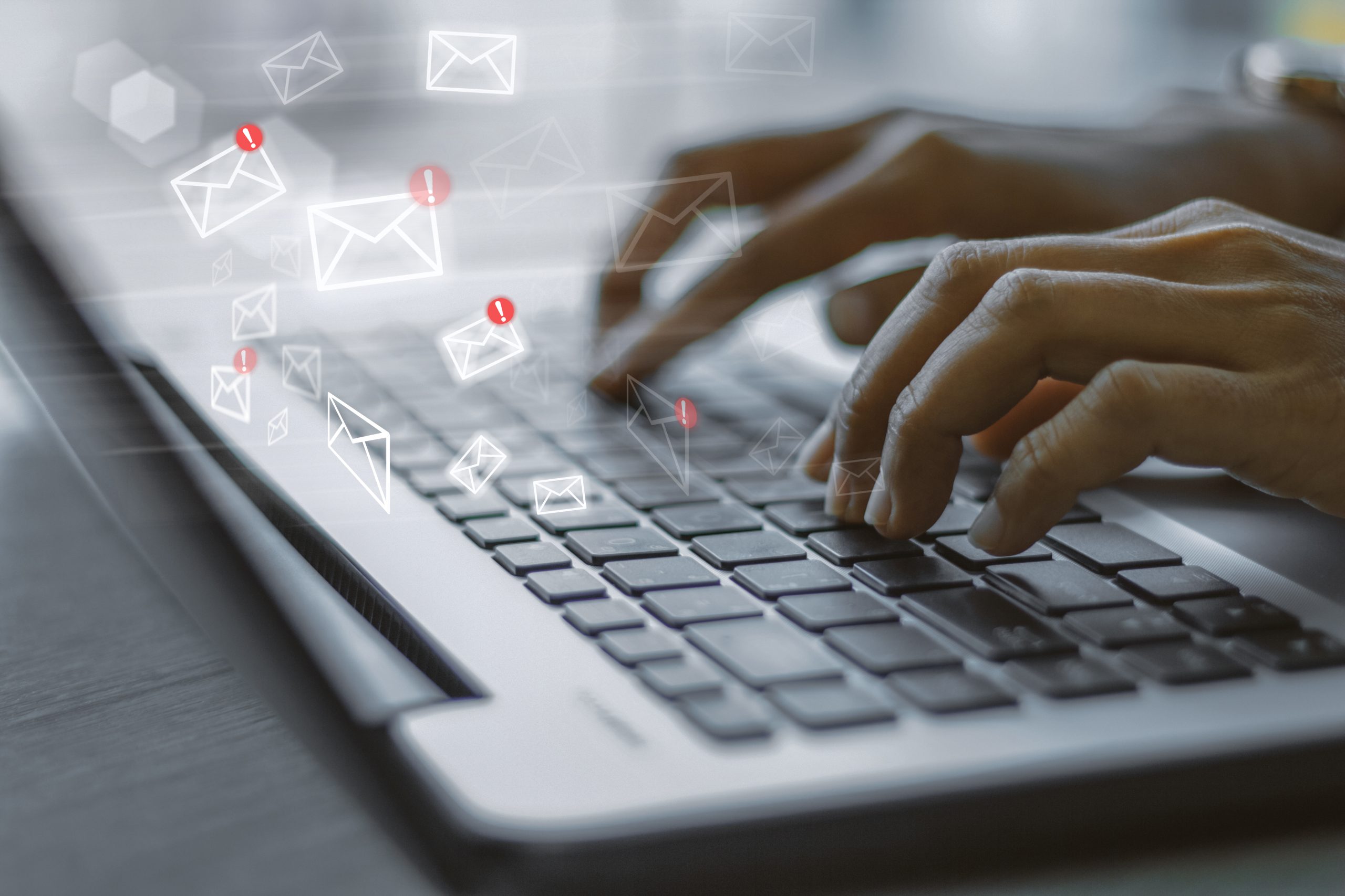 Hands typing emails marked as important.