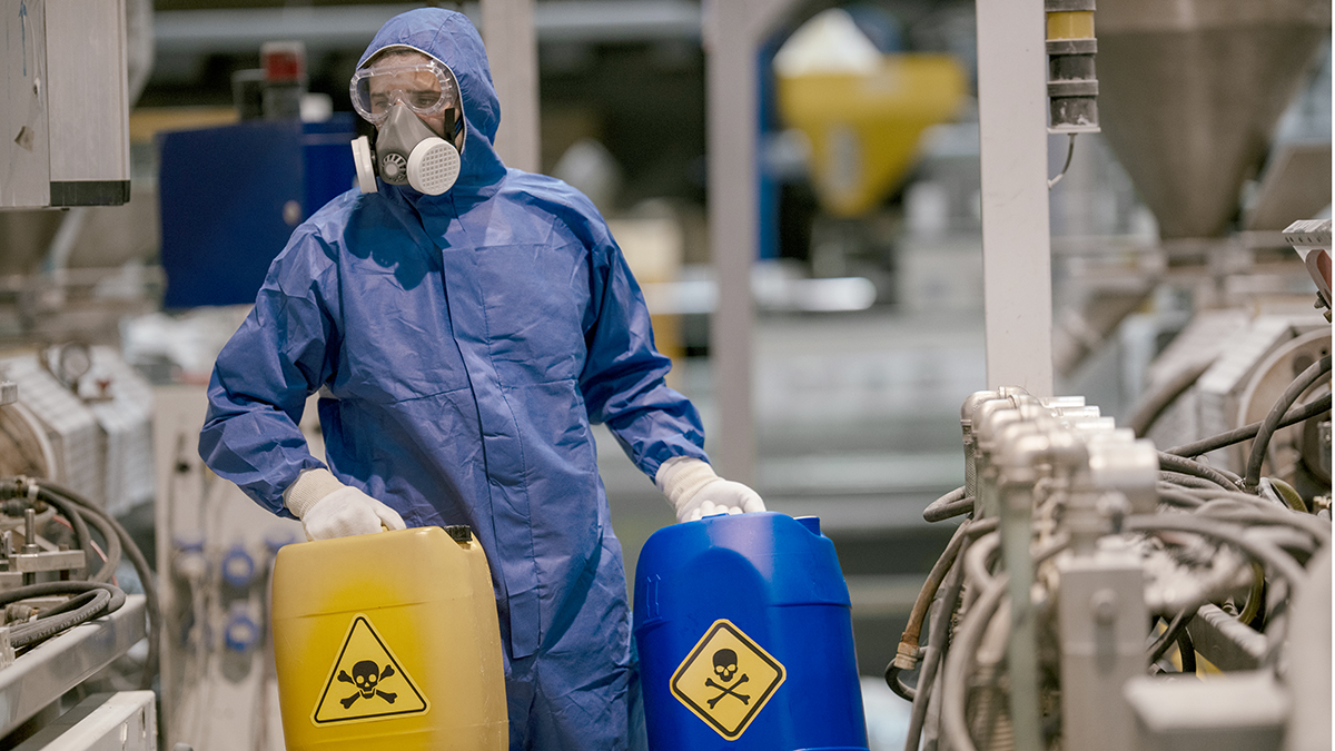 Factory worker working with dangerous materials