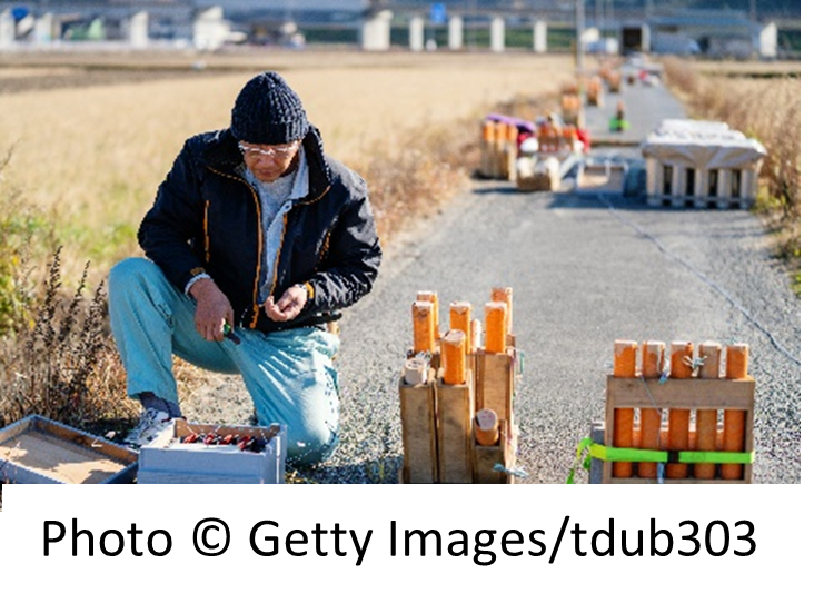 Individual setting up fireworks for detonation.