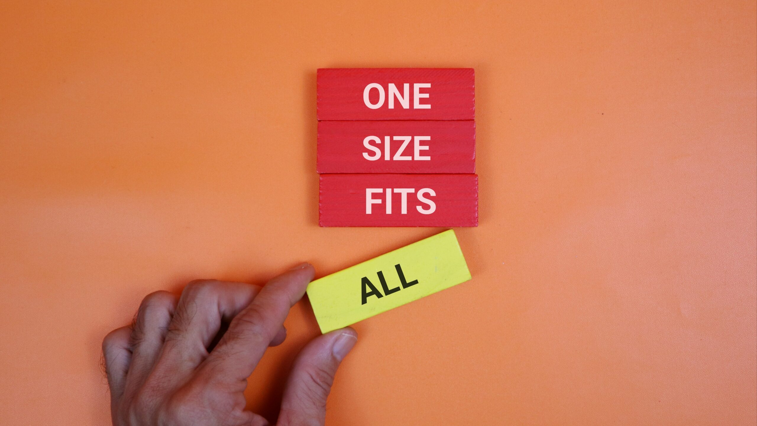 Small blocks each with a word that says one size fits all, with a hand removing "all"