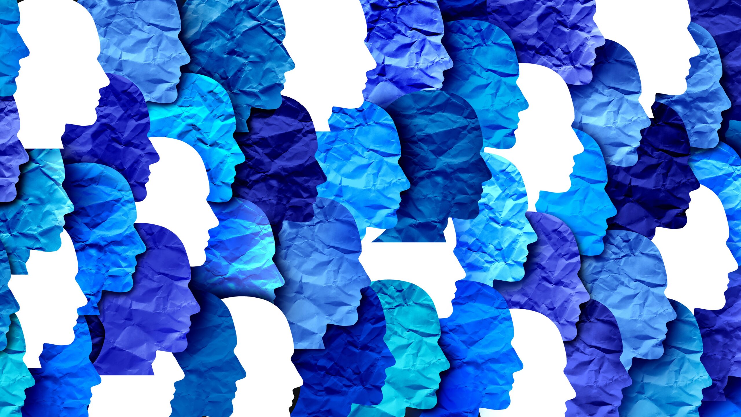 Many face profiles made of paper overlapping