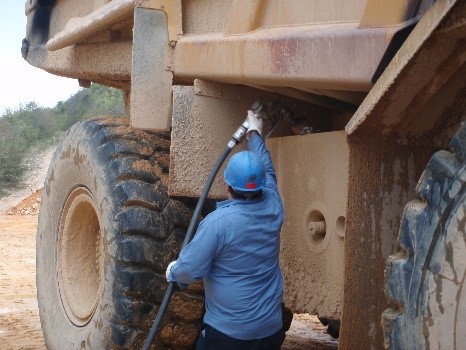Surface miner reaches overhead to fuel machinery.