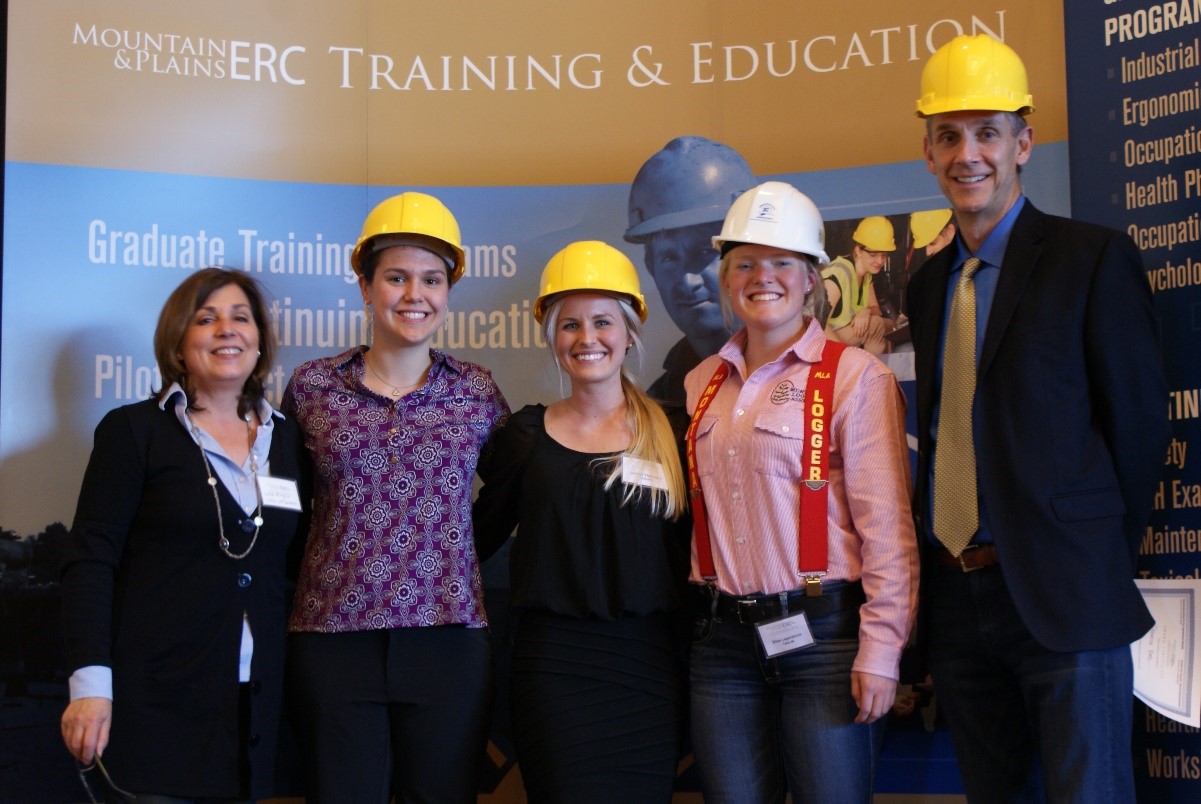 Group of people wearing hard hats posing for a photo