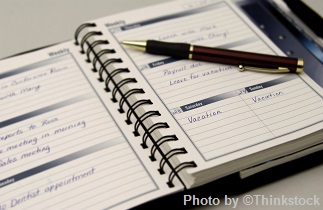 M10E A daily planner is open with a pen on top