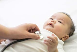 Doctor examining infant.
