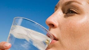 Close-up photos of a person's face with the person drinking a glass of water.