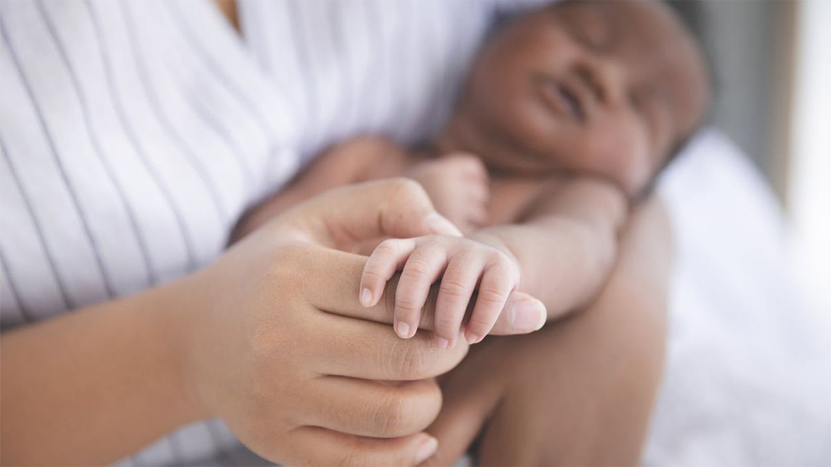 person holding a newborn
