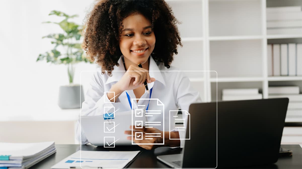 Healthcare provider working on laptop with a graphic of a survey overlaid on the photo