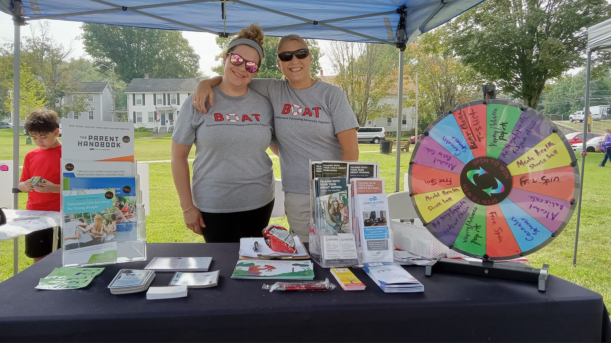 Two adults staffing the BOAT coalition table at community event