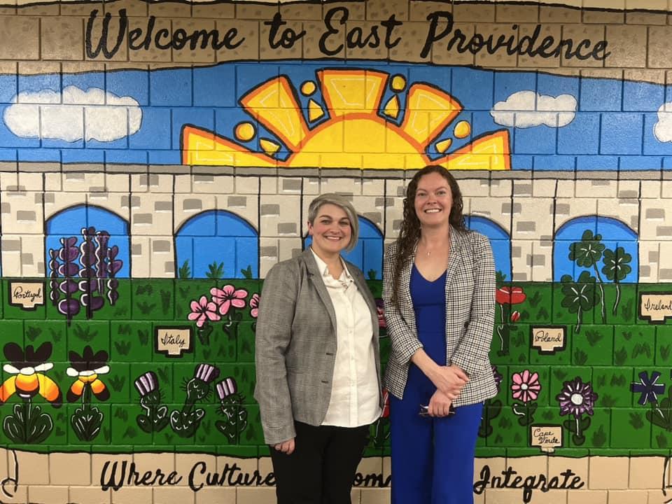 East Providence Prevention Coalition staff in front of a community mural
