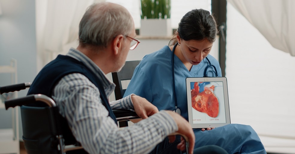 Doctor reviewing medical process of heart with patient