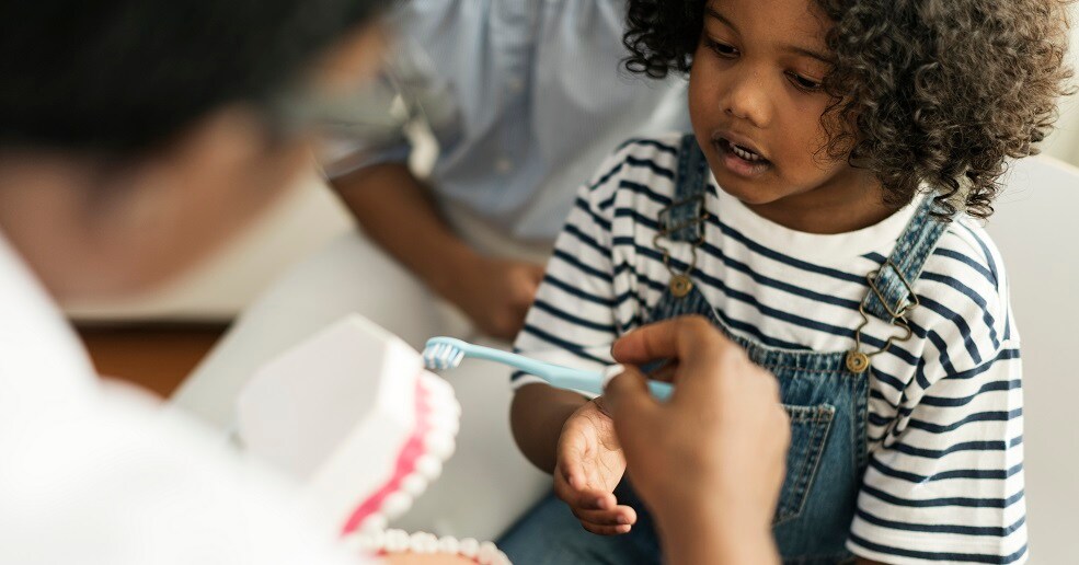 Dentist working with young male patient