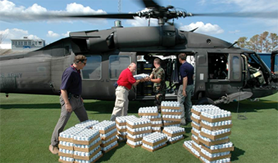Men load supplies into a helicopter.