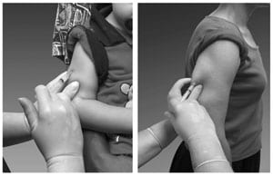 Upper arm being pinched by a hand and injected with a small syringe.