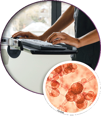 Health care workers hands on computer keyboard and a close view of germs