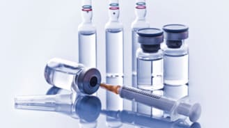 needle syringe and vials of medicine