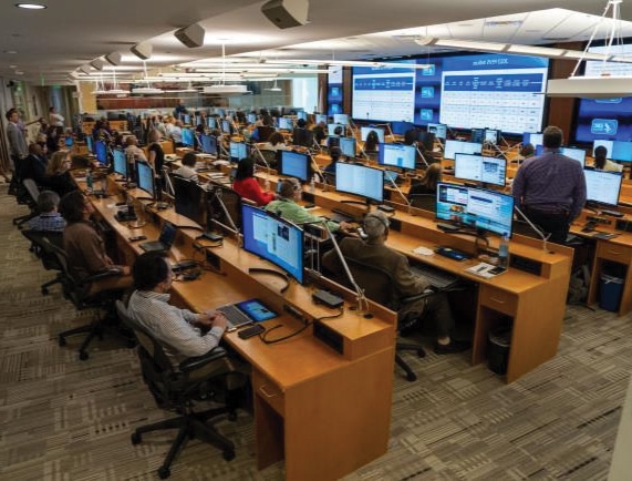 Public health officials sitting in front of computers at CDC's Emergency Operations Center