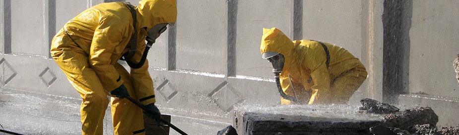 Workers in Has-Mat suites decontaminating a public area.