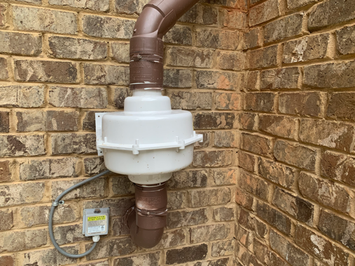 A Radon reduction vent pipe outside of a home