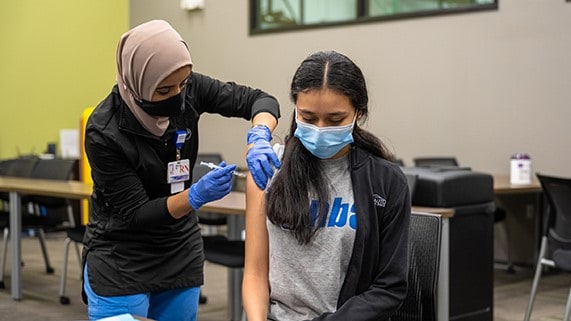 A person getting a vaccine at a clinic.