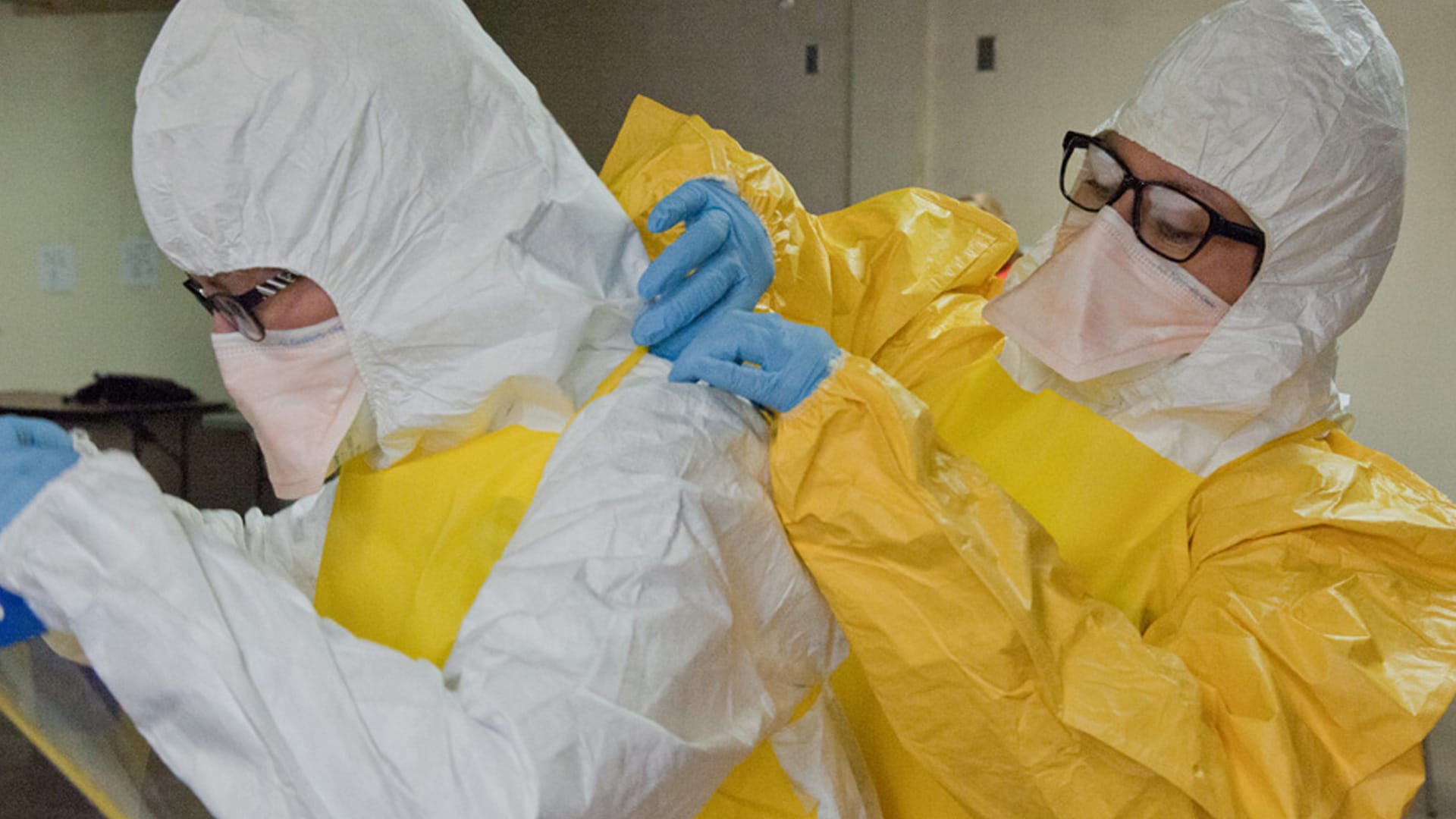 Healthcare workers putting on PPE.