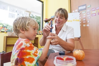 A school nurse administering a diabetes blood check for a student.