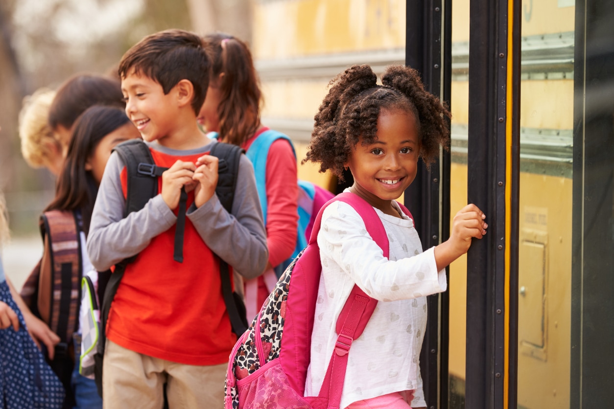 Young girl about to get on the school bus.