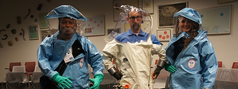 Science Ambassador Fellows trying on personal protective equipment at the CDC museum