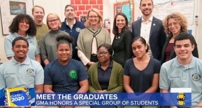 Group of people with text banner at the bottom. Text reads "Meet the graduates. GMA honors a special group of students."