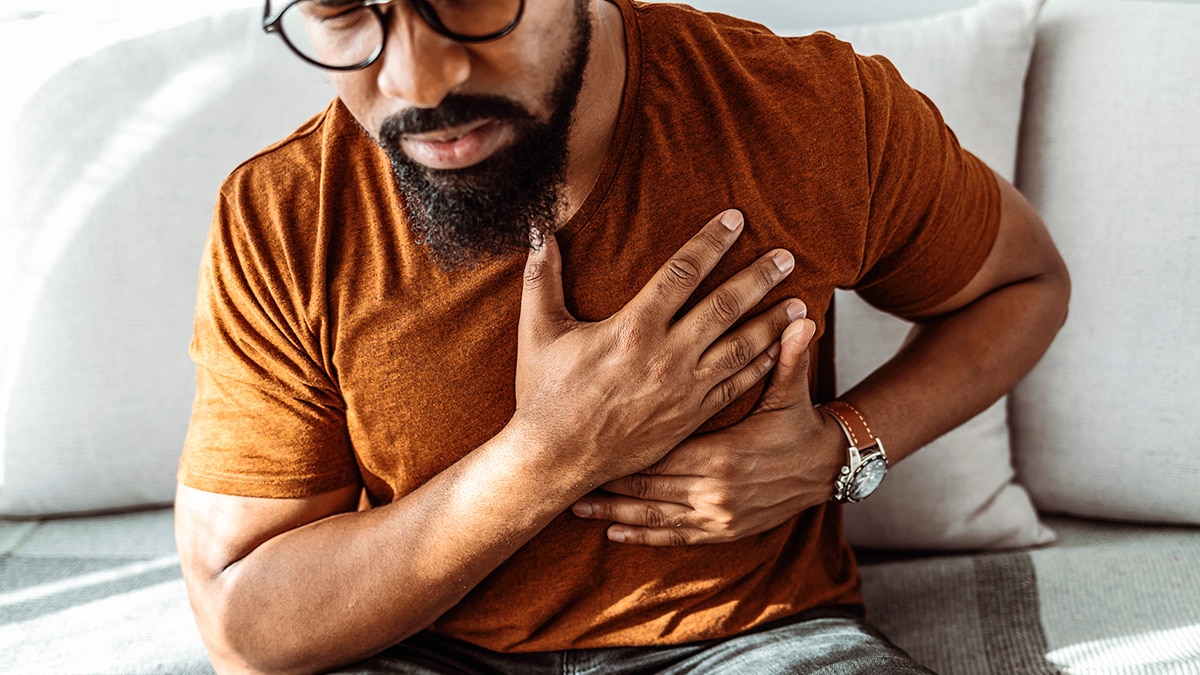 A man holding his chest in pain.