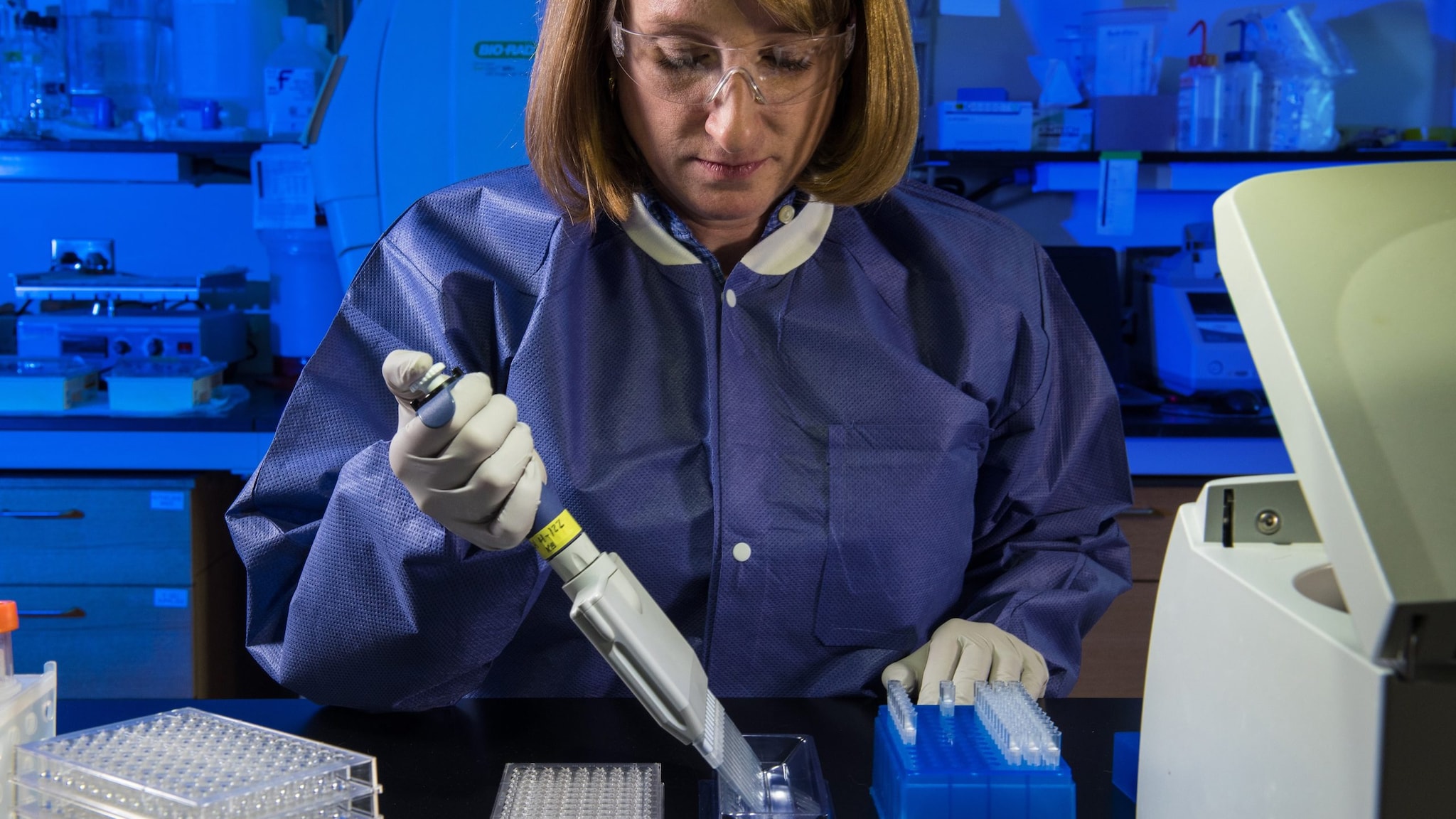Lab worker holding a pipette running a test
