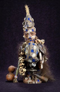 A statue with blue and gold colors, representing the West African god of smallpox.