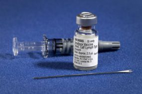 Vial of smallpox vaccine and two-pronged needle