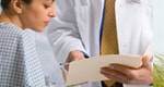 Female patient reviewing chart with doctor.