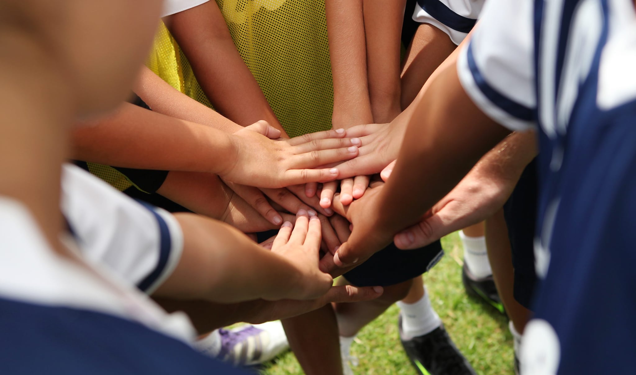 Sports team stacking their hands