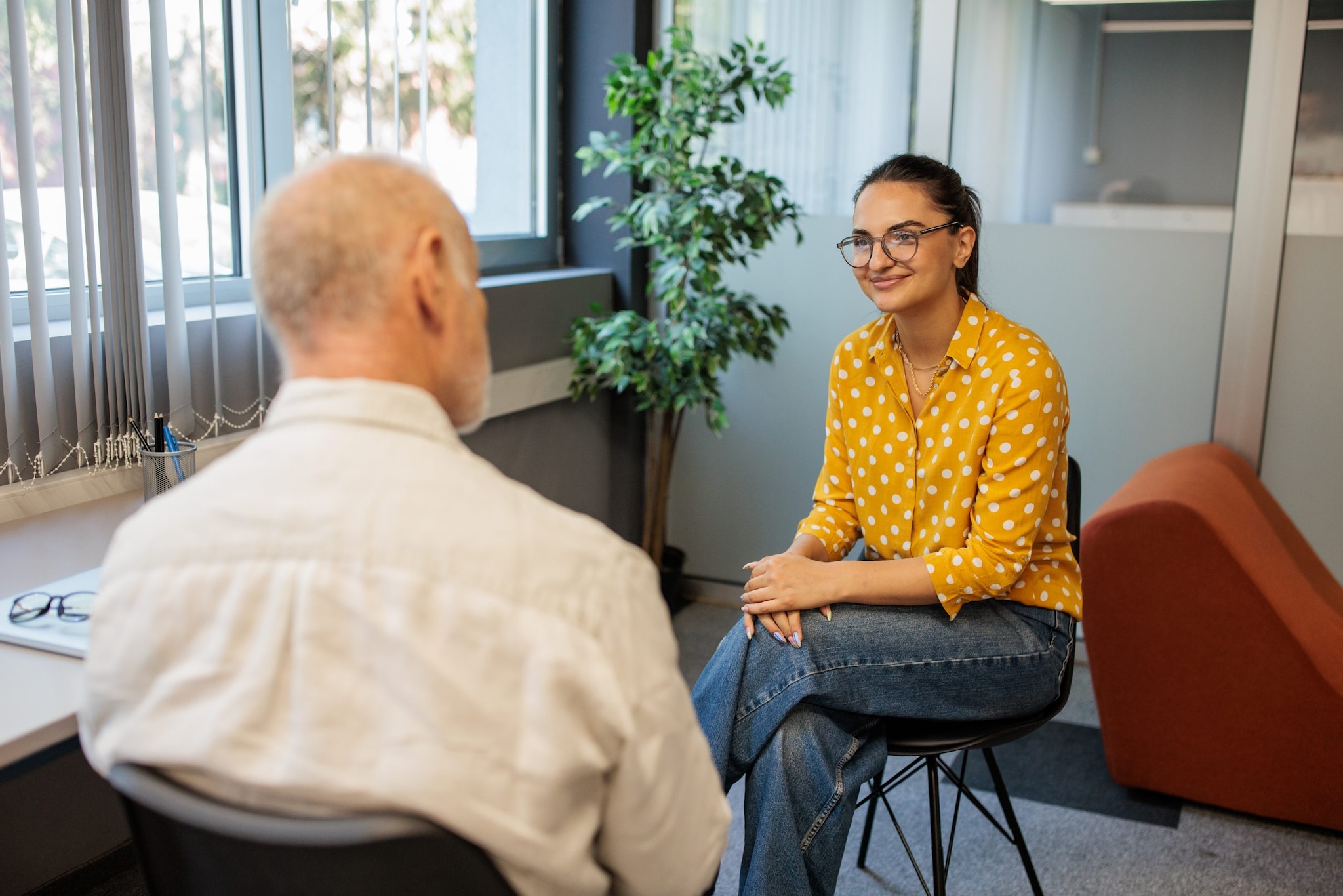 Woman and man sitting across from each other in an office.