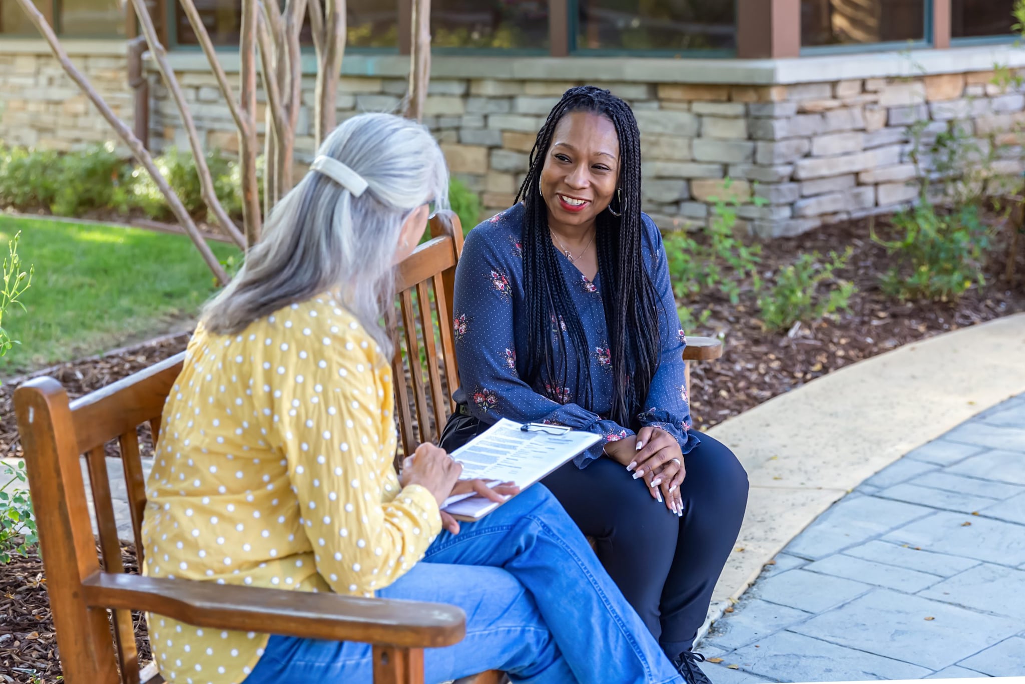 Two women talking on a bench