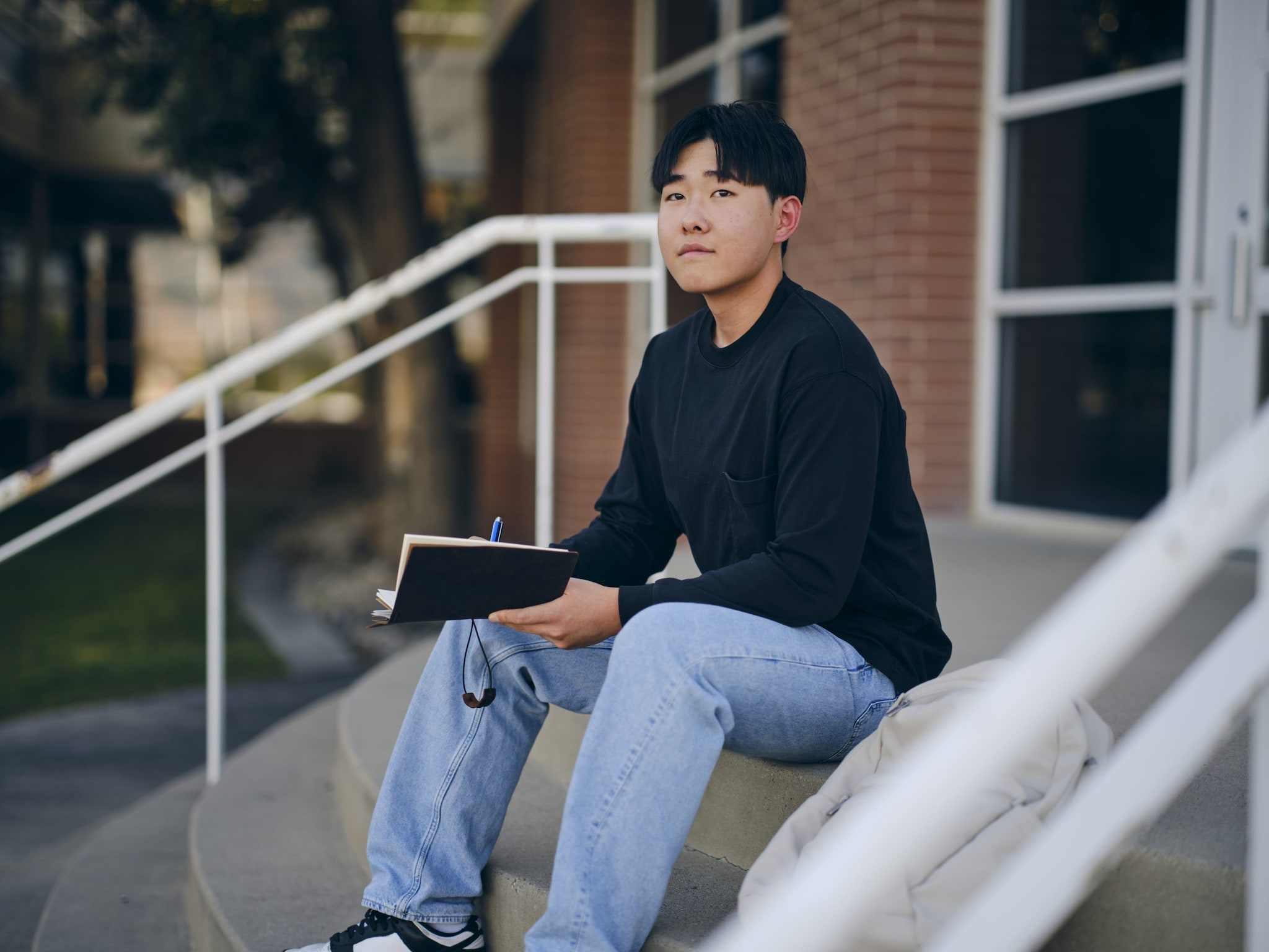 Young man looking up from a book