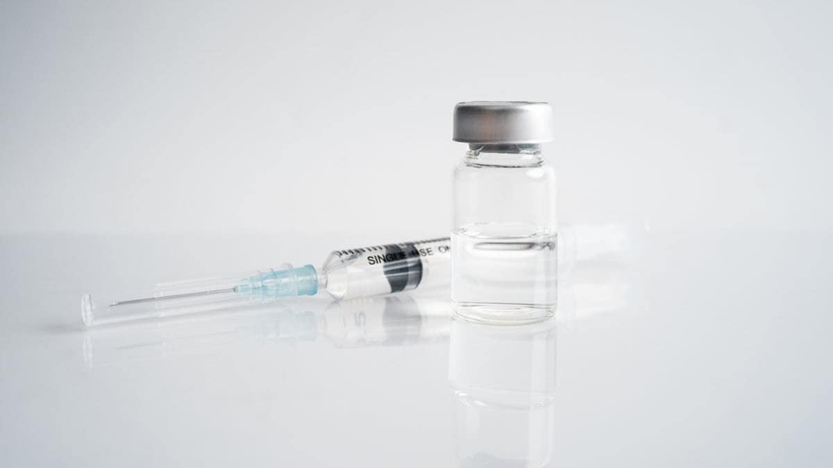 Syringe and vials, isolated on white background