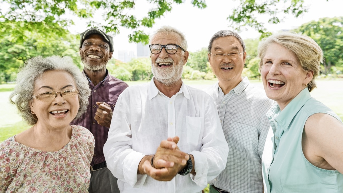 5 older people of various ethnicities outdoors