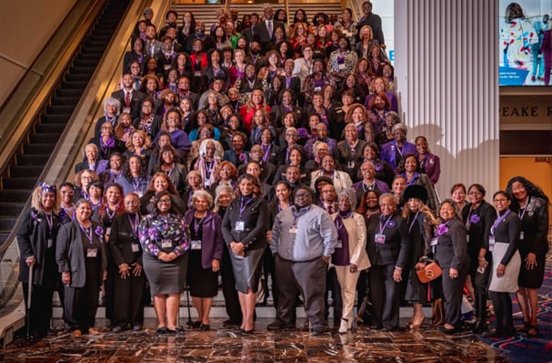 A group of people pose on a staircase at the NCNW 61st National Convention