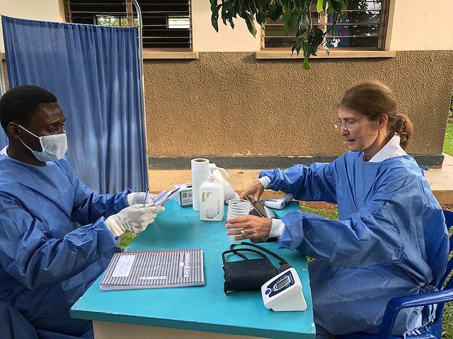 CDC’s Rosalind Carter and a Ugandan colleague prepare to give the Ebola vaccine to health workers in northwestern Uganda in July 2019.