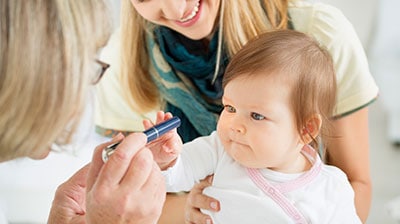 giving a baby an eye exam